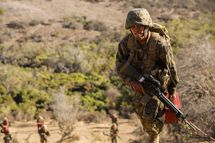 Private Justin C. Pasadava, Platoon 3214, India Company, 2nd Recruit Training Battalion, carries a re-supply of ammunition up a hill during an event on the Crucible at Marine Corps Base Camp Pendleton, Oct. 29. Pasadava was homeless throughout some of his child hood and used his experiences to help him with his future endeavors. Pasadava is a native of Honolulu and was recruited out of Recruiting Station Honolulu.