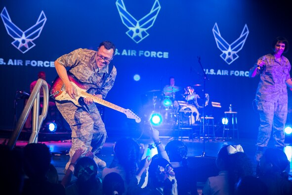 Staff Sgt. Gregory Lacy plays a guitar solo during a Red Ribbon Week concert Oct. 22, 2014, at the Edgewood Theater for Performing Arts in San Antonio, Texas. Lacy is a solo guitarist for the Band of the West horn band "Warhawk," The band performed a free concert to promote Red Ribbon Week, which endorses the full potential of healthy, drug free youth. (U.S. Air Force photo/Joshua Rodriguez)