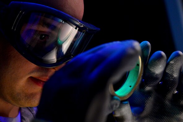 Airman 1st Class Michael Griffin utilizes a stationary penetrant line Nov. 3, 2014, at Langley Air Force Base, Va. A penetrant is used to detect discontinuities, such as cracks and pits, open to the surface on parts made of nonporous materials. Griffin is a 1st Maintenance Squadron nondestructive inspection technician. (U.S. Air Force photo/Staff Sgt. Antoinette Gibson)