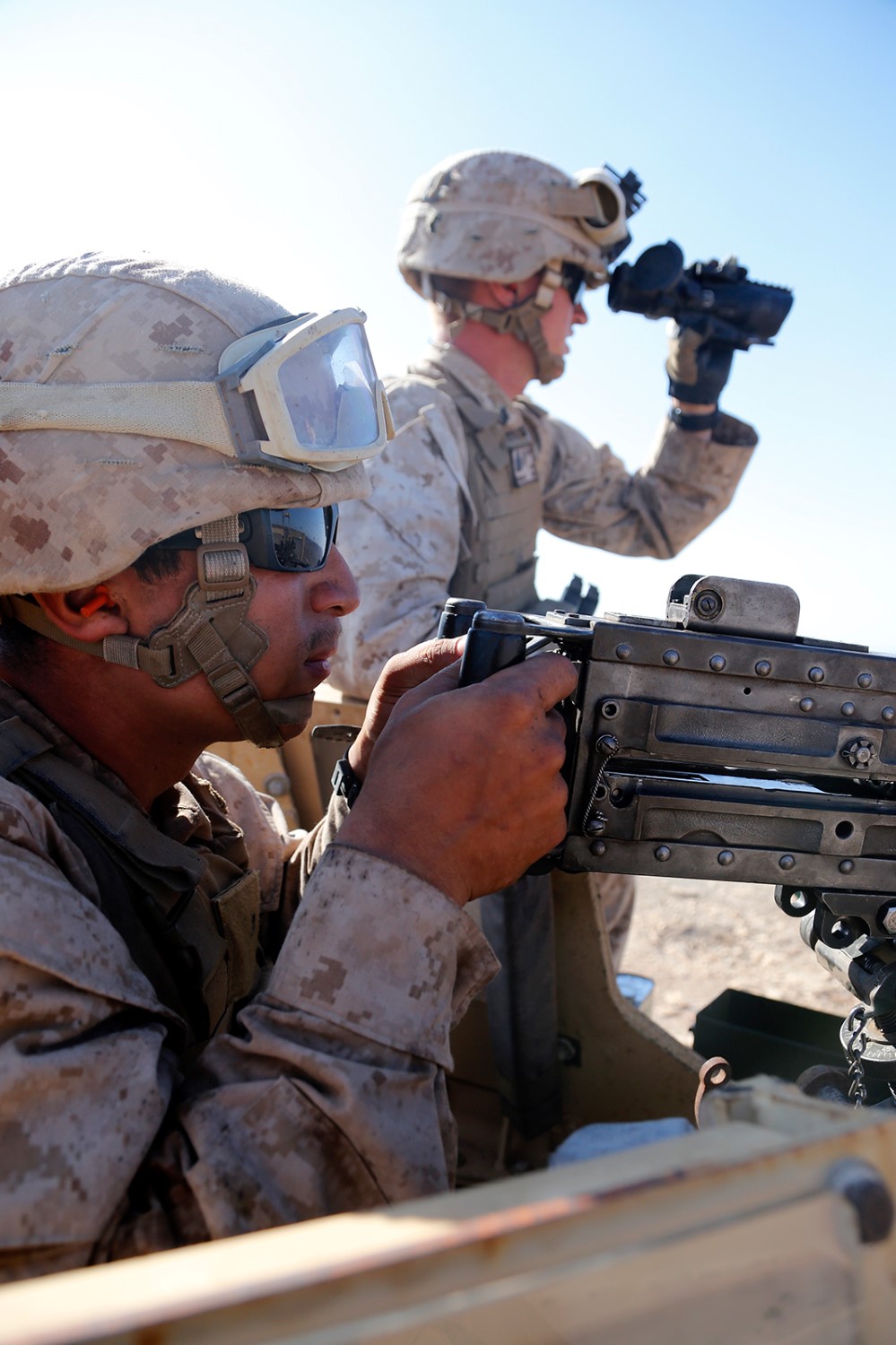 U.S. Marine Corps Lance Cpl. Vincent T. Carrillo, left, a landing support specialist with Combat Logistics Battalion 11, 11th Marine Expeditionary Unit (MEU), and native of Palmdale, California, fires a .50-caliber machine gun from the turret of a 7-ton truck during a live-fire static crew-served weapons range as part of sustainment training at D’Arta Plage, Djibouti, Nov. 5. The 11th MEU is deployed as a theater reserve and crisis response force throughout U.S. Central Command and the U.S. 5th Fleet area of responsibility. (U.S. Marine Corps photos by Gunnery Sgt. Rome M. Lazarus/Released) 