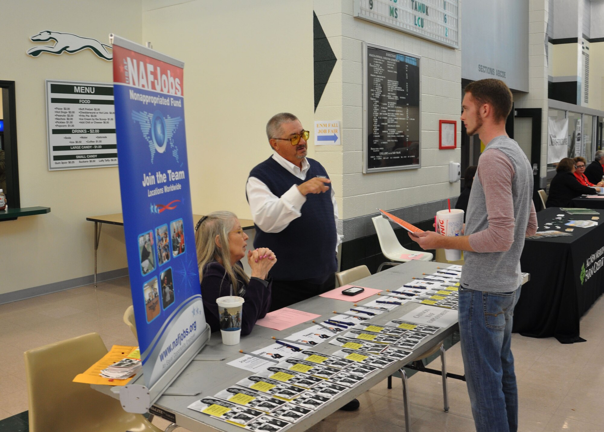 Patty Vaughn, 27th Special Operations Force Support Squadron Non-Appropriated Funds chief human resource officer, and Bob Weber, 27 SOFSS NAF resource assistant, speak to an interested employment prospect about openings at the regional Fall Job Fair held Nov. 5, 2014 at Eastern New Mexico University’s Greyhound Arena in Portales, N.M. Local military and civilian talent pools were presented with an abundance of local, regional, and national businesses ready to hire, some on the spot. (U.S. Air Force photo/Marc Calero) 
