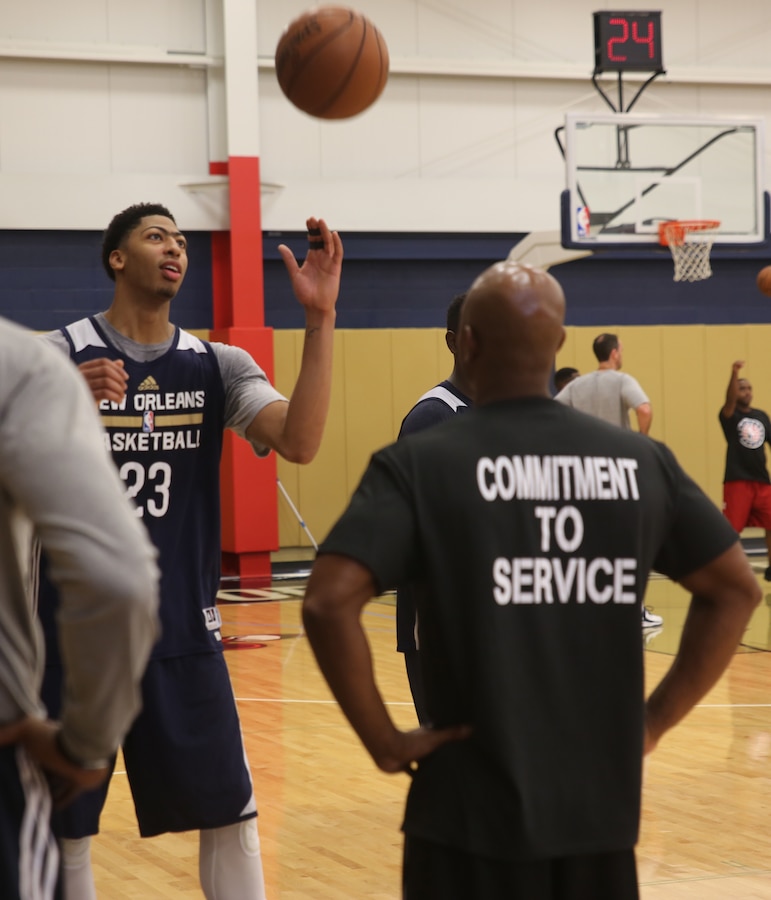 Anthony Davis (left), a center-forward with the New Orleans Pelicans catches a rebound during a practice session at the Pelicans’ practice facility in Metairie, La., Nov. 6, 2014. Marines with Marine Forces Reserve also participated in the practice as part of NBA Cares Hoops for Troops Week.