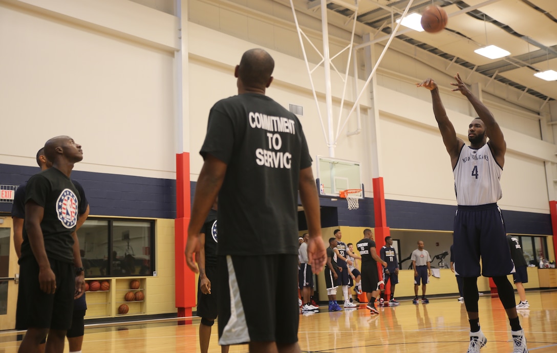 Patric Young (right), a guard from the New Orleans Pelicans shoots a free throw during a practice session at the Pelicans Practice Facility in Metairie, La., Nov. 6, 2014. Marines with Marine Forces Reserve also participated in the practice as part of NBA Cares Hoops for Troops Week.