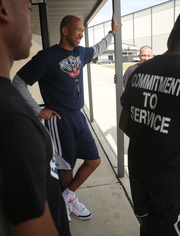 Monty Williams (center), New Orleans Pelicans head coach, speaks with Marines from Marine Forces Reserve, New Orleans during a tour of the Pelicans’ practice facility in Metairie, La., Nov. 6, 2014. The Marines had an opportunity to practice with the players, tour the facility and eat lunch at the Pelicans’ cafeteria for NBA Cares Hoops for Troops Week.