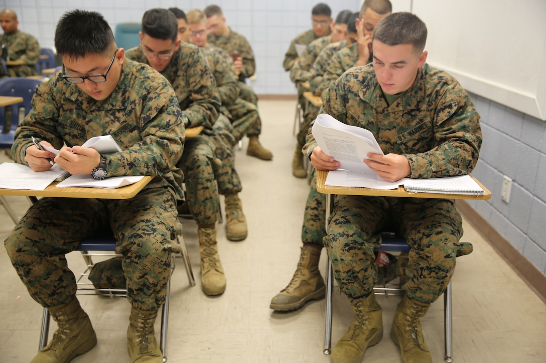 Marines with Marine Wing Communications Squadron 28 read “Our Ethos” during a command-sponsored Lance Corporal Leadership and Ethics Seminar at Marine Corps Air Station Cherry Point, N.C., Nov. 3, 2014. Lance corporals across the Corps must complete a command-sponsored leadership and ethics seminar before being considered eligible for the rank of corporal. 