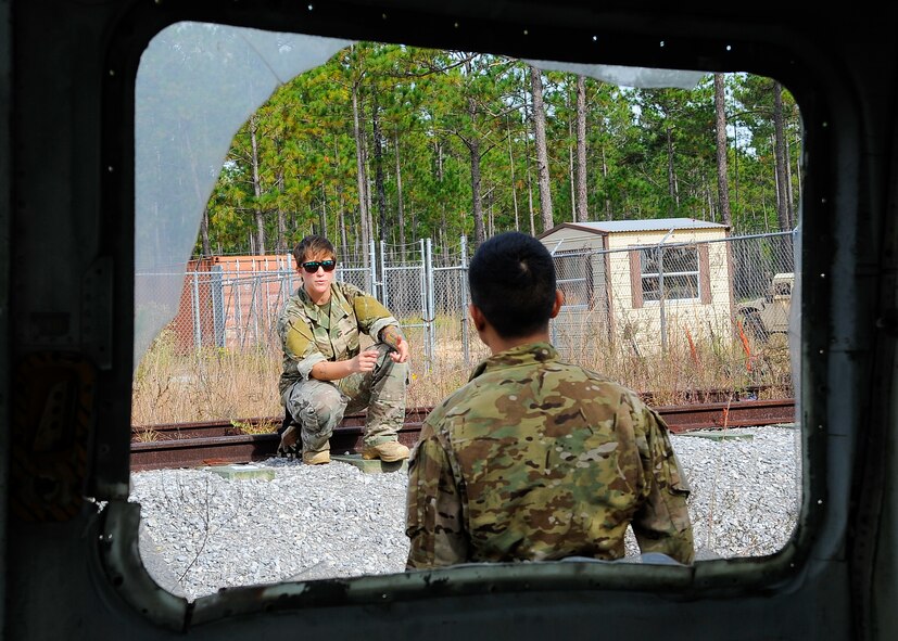 Staff Sgt. Charlene Plante, 1st Special Operations Support Squadron Survival, Evasion, Resistance and Escape Specialist, explains an urban environment scenario to a student in her Code of Conduct Continuation training class at B-76 Urban Training Area, Eglin Range, Fla., Nov. 5, 2014. In today’s warfare an urban environment is a common place for Air Commando deployments. (U.S. Air Force photo/Airman 1st Class Andrea Posey)
