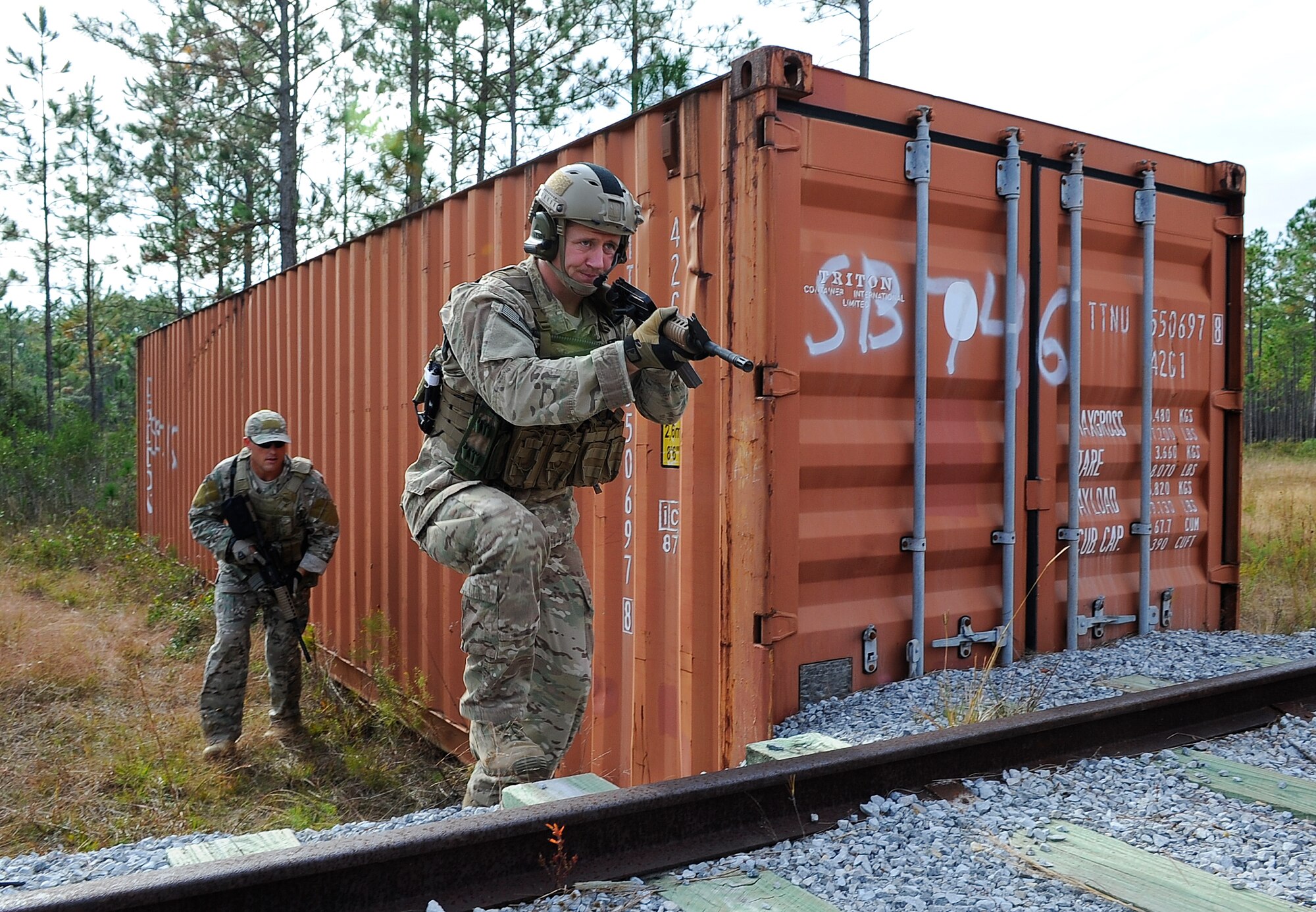 Staff Sgt. Kenneth Paxon, 1st Special Operations Support Squadron Survival, Evasion, Resistance and Escape Specialist, demonstrates how to strategically cross a railroad at B-76 Urban Training Area, Eglin Range, Fla., Nov. 5, 2014. When crossing open areas, with little cover, an Airman must be alert and swift. (U.S. Air Force photo/Airman 1st Class Andrea Posey)