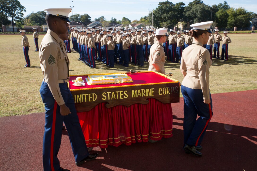 Marines from Marine Forces Reserve carry the cake during the cake cutting ceremony in honor of the Marine Corps’ 239th birthday at Marine Corps Support Facility New Orleans, La., Nov. 7, 2014. The ceremony is a tradition in which a piece of cake is passed from the oldest Marine to the youngest Marine, symbolizing the passage of knowledge between generations. 