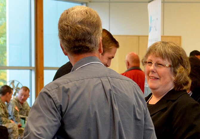 Kay Baltz, small business programs manager for the Corps' Walla Walla District, helps "Industry Day" attendees learn how to compete for government contracts during the free day-long seminar held Oct. 30 at Walla Walla Community College’s Water and Environment Center.