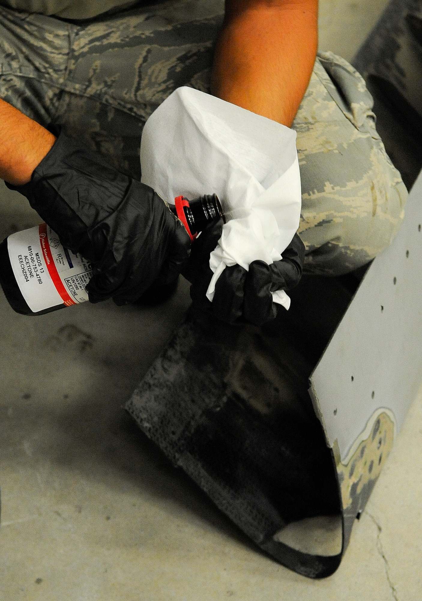 Senior Airman Troy Bannon, 1st Special Operations Equipment Maintenance Squadron aircraft structural maintenance apprentice, wipes down a CV-22 Osprey leading edge on Hurlburt Field, Fla., Nov. 3, 2014. The leading edge must be cleaned before a patch can be applied to the corroded area. (U.S. Air Force photo/Airman 1st Class Andrea Posey)