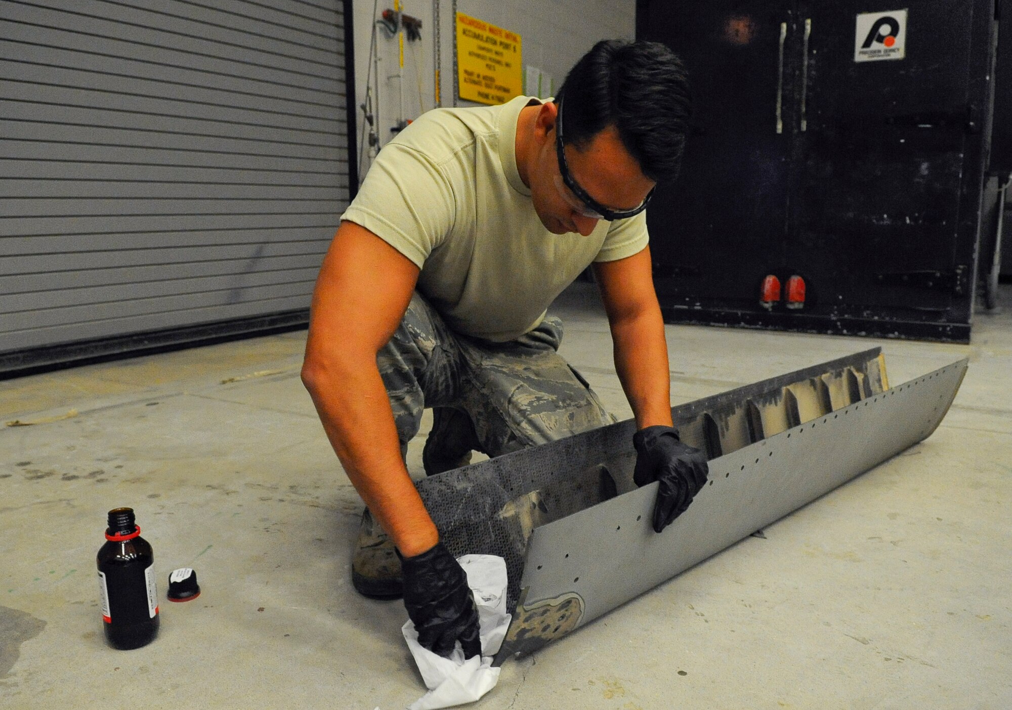 Senior Airman Troy Bannon, 1st Special Operations Equipment Maintenance Squadron aircraft structural maintenance apprentice, wipes down a CV-22 Osprey leading edge on Hurlburt Field, Fla., Nov. 3, 2014. The leading edge must be cleaned before a patch can be applied to the corroded area. (U.S. Air Force photo/Airman 1st Class Andrea Posey)