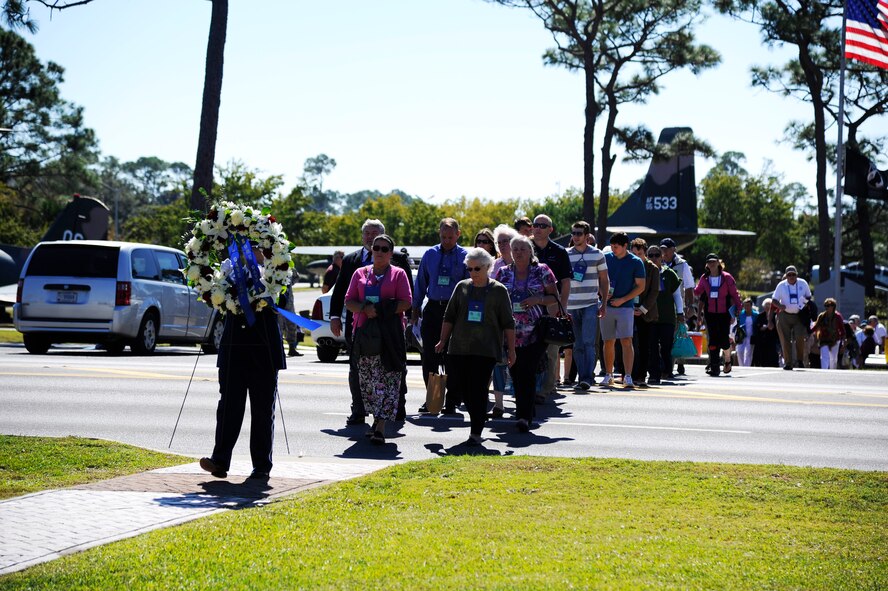 A Hurlburt Field Honor Guard Airman carries a wreath that will be placed next to the Forward Air Controllers memorial monument at the Air Park on Hurlburt Field, Fla., Oct. 25, 2014. Nearly 300 former FACs, their families and friends, and Hurlburt Airmen paid tribute to those who lost their lives in past wars. (U.S. Air Force photo/Staff Sgt. Sarah Hanson)