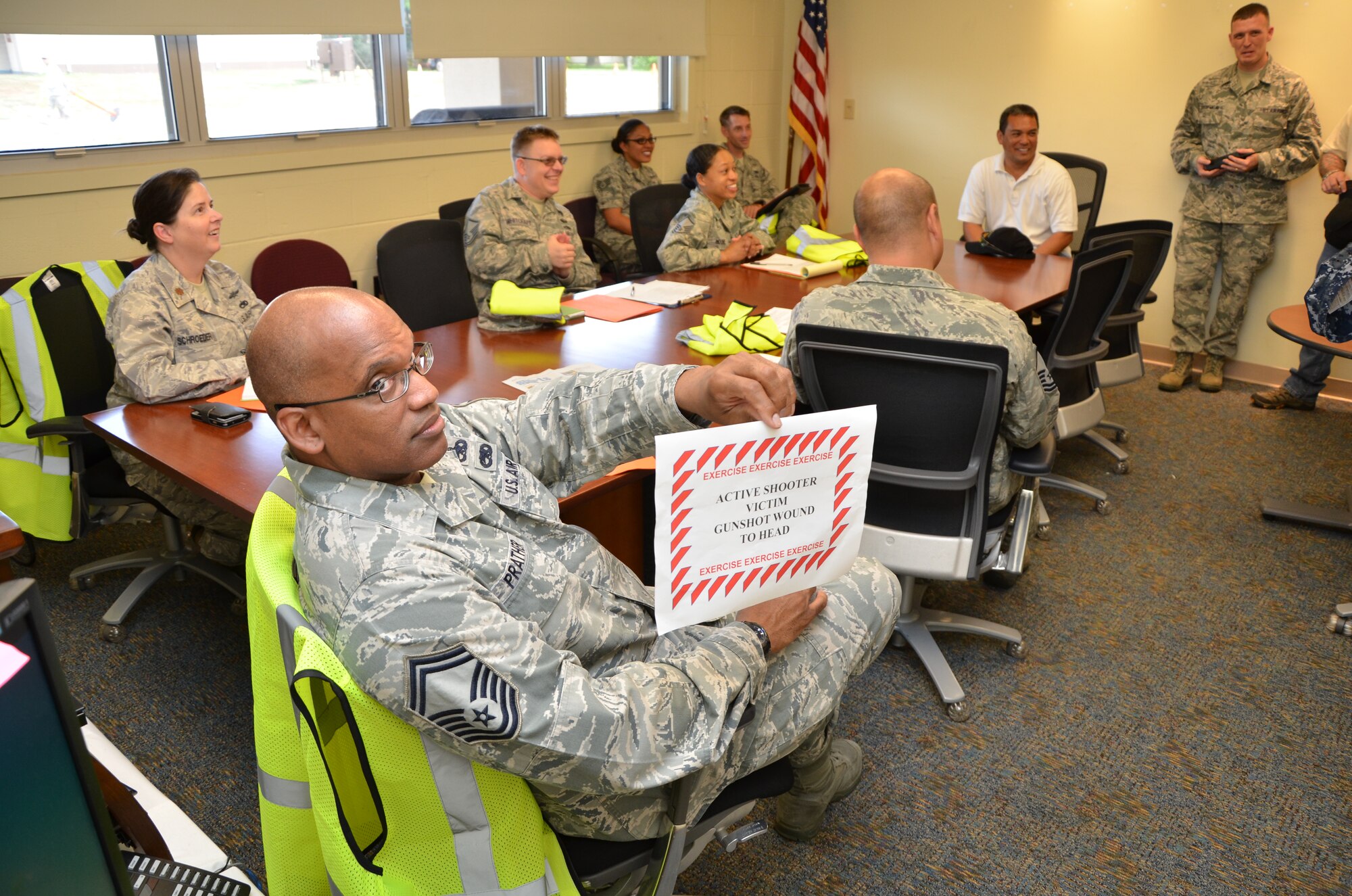 Senior Master Sgt. Robert Prather, superintendent of logistics and plans with the 624th Regional Support Group, holds up an exercise card during an after-action discussion for an active shooter exercise the unit staged during a unit training assembly, Joint Base Pearl Harbor-Hickam, Hawaii, Sept. 9, 2014. Prather is a member of the 624th RSG’s Wing Inspection Team and observed the exercise as outlined in Air Force Instruction 90-201, The Air Force Inspection System. (U.S. Air Force photo by Tech. Sgt. Phyllis Keith)