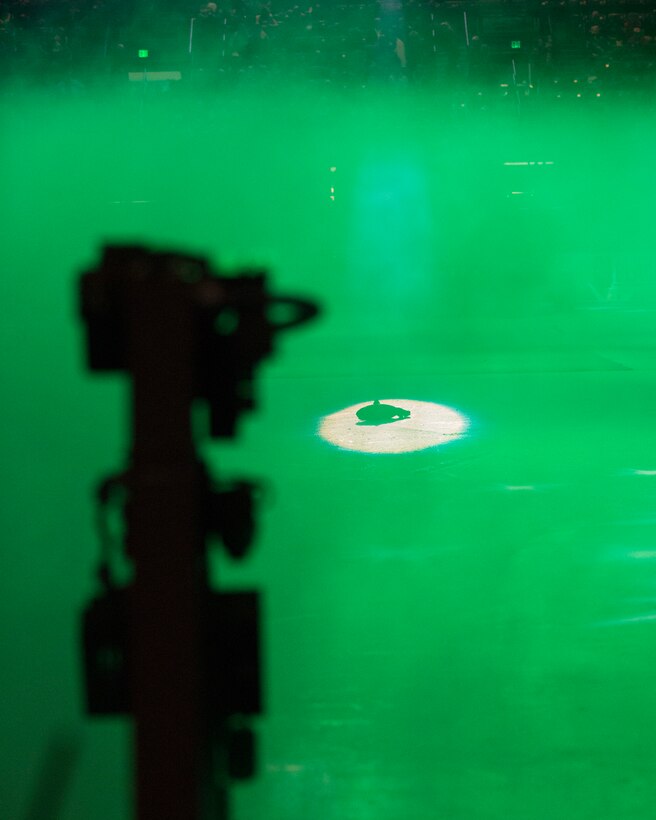 A rubber fish lays on the ice rink as an Explosive Ordnance Disposal Wolverine Robot proceeds to inspect it, Nov. 5, 2014, as part of a military demonstration at a Colorado Eagles hockey game in Loveland, Colo. Airmen from 90th Civil Engineering Squadron EOD flight and former Navy SEALs participated in the demonstration showcasing the robot's capabilities. (U.S. Air Force photo by Lan Kim)
