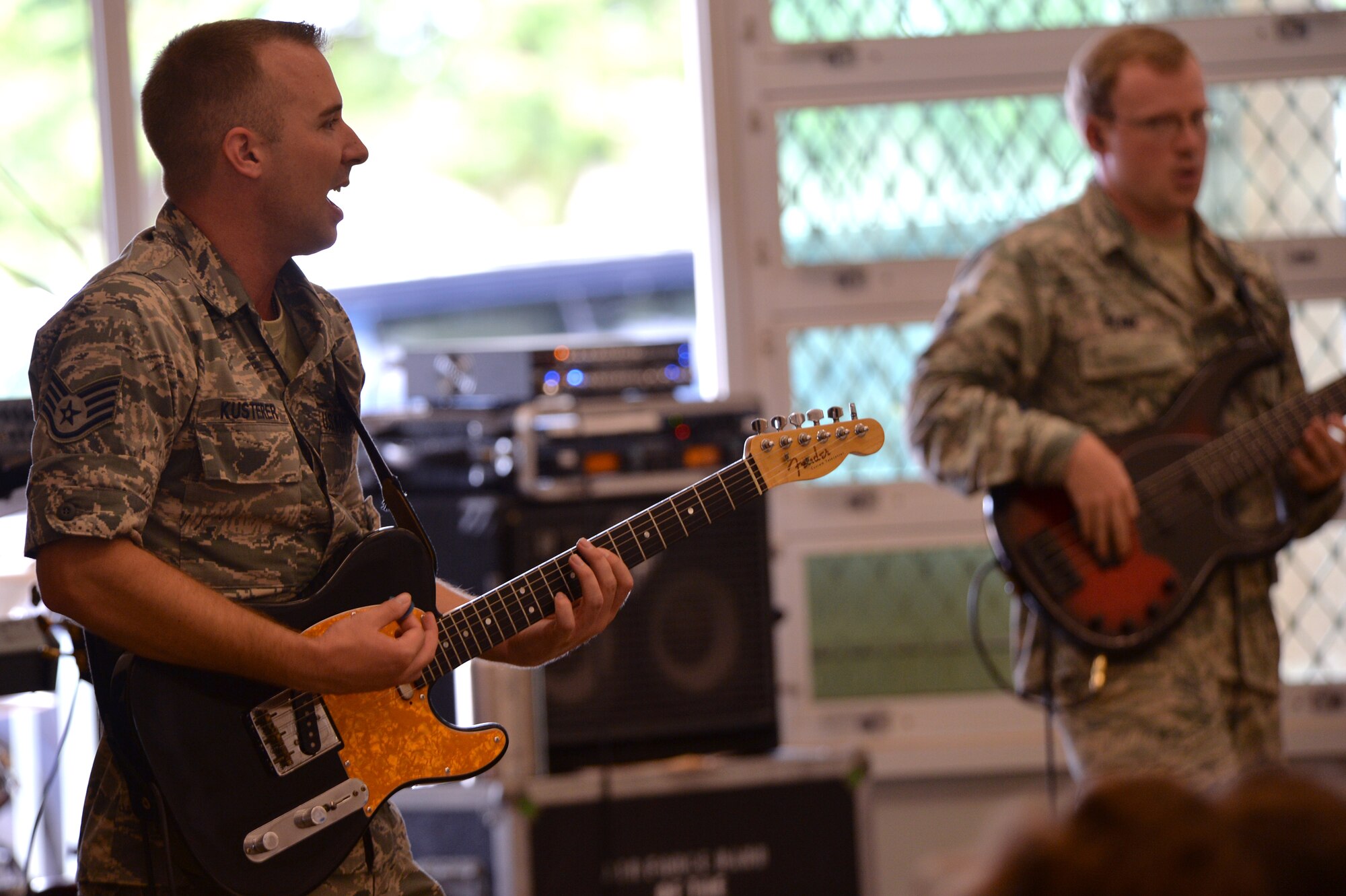 Staff Sgt. Aaron Kusterer, a guitarist with the U.S. Air Force Band of the Pacific-Hawaii, performs a song for Kapolei Elementary School students and faculty members in Kapolei, Hawaii, Nov. 5, 2014. The performance was part of the school’s observance of National Red Ribbon Week that raises awareness of the effects of drug use. (U.S. Air Force photo by Staff Sgt. Alexander Martinez)  