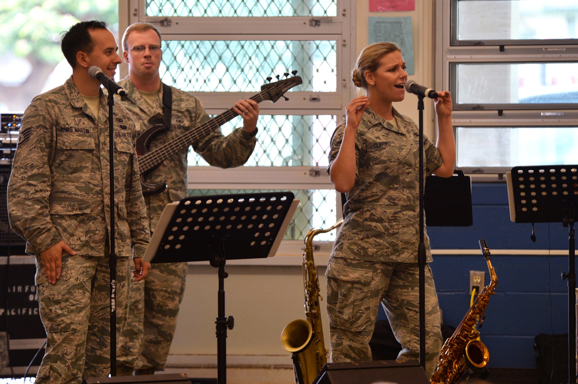 (From left) Staff Sgt. Devin Rivas Martin and Staff Sgt. Courtney Clifford, vocalists with the U.S. Air Force Band of the Pacific-Hawaii, perform a song for Kapolei Elementary School students and faculty members in Kapolei, Hawaii, Nov. 5, 2014. The performance was part of the school’s observance of National Red Ribbon Week that raises awareness of the effects of drug use. (U.S. Air Force photo by Staff Sgt. Alexander Martinez)  