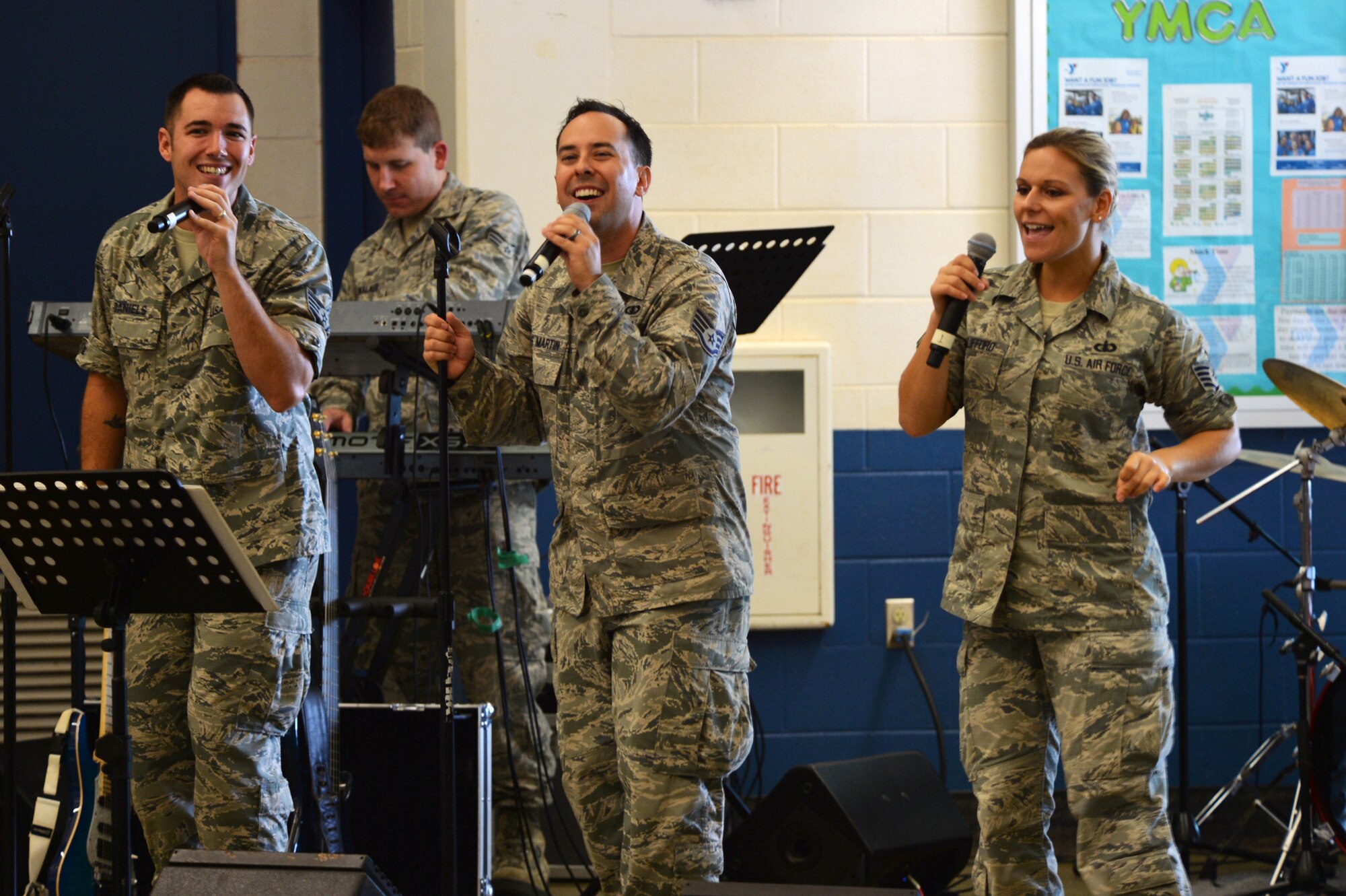 Members of Hana Hou!, the rock band of the U.S. Air Force Band of the Pacific-Hawaii, perform a song for Kapolei Elementary School students and faculty members in Kapolei, Hawaii, Nov. 5, 2014. The performance was part of the school’s observance of National Red Ribbon Week that raises awareness of the effects of drug use. (U.S. Air Force photo by Staff Sgt. Alexander Martinez)  