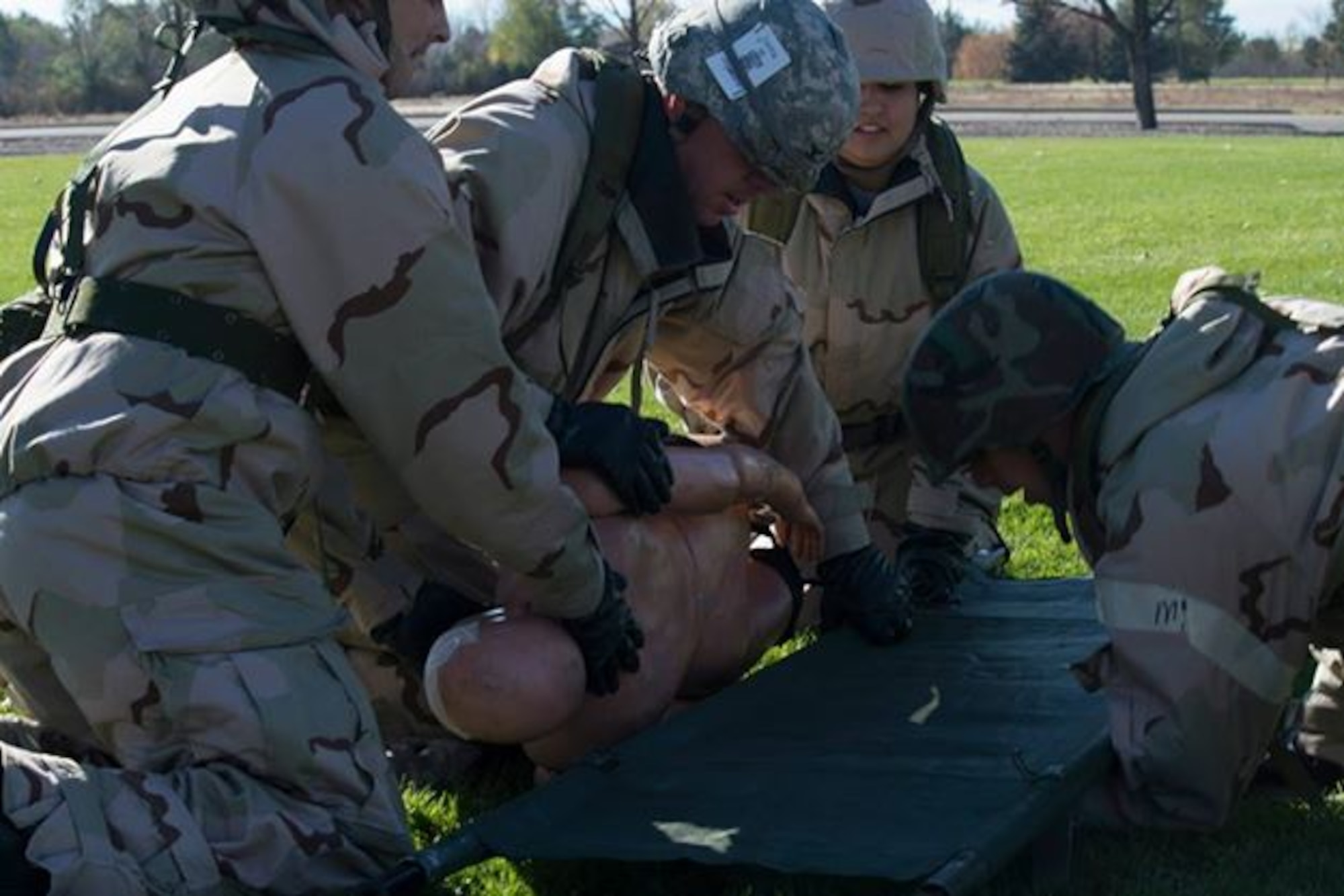 A group of medical personnel practice placing a patient onto a litter for evacuation at Mountain Home Air Force Base, Idaho, Nov. 6, 2014. The 366th Medical Group took part in three days of training for the Capstone Training Event. (U.S. Air Force photo by Airman 1st Class Jessica H. Smith/RELEASED)