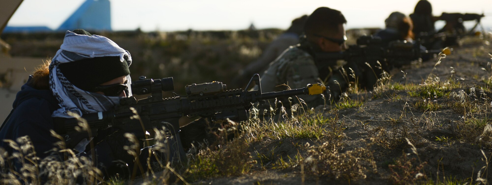 Airmen dressed as opposing forces simulate fire during a training event at Saylor Creek Range, Idaho, Nov. 5, 2014. OPFOR simulated various attacks throughout the training event, which lasted five days. (U.S. Air Force photo by Airman 1st Class Malissa Lott/RELEASED)