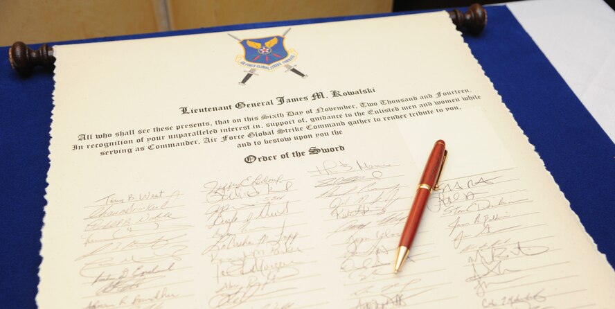 A scroll signed by enlisted personnel renders tribute to Lt. Gen. James Kowalski, deputy commander of U.S. Strategic Command, at Air Force Global Strike Command’s inaugural Order of the Sword induction ceremony at Barksdale Air Force Base, La., Nov. 6, 2014. Kowalski, who served as commander of AFGSC from Jan. 2011 to Oct. 2013, was chosen by the enlisted corps to become the first inductee of the Order for his significant contributions to the welfare and prestige of the Air Force enlisted force and mission effectiveness. (U.S. Air Force photo by Airman 1st Class Joseph Raatz/Released)