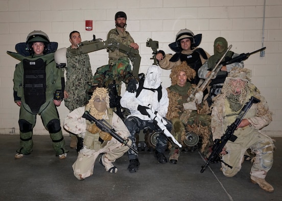 90th Civil Engineering Squadron Explosive Ordnance Disposal flight Airmen and former Navy SEALs pose for a group photo with the EOD Wolverine Robot, Nov. 5, 2014, during a Colorado Eagles hockey game in Loveland, Colo. Ninetieth CES EOD flight Airmen and the SEALs participated in a demonstration for military appreciation night. (U.S. Air Force photo by Lan Kim)

