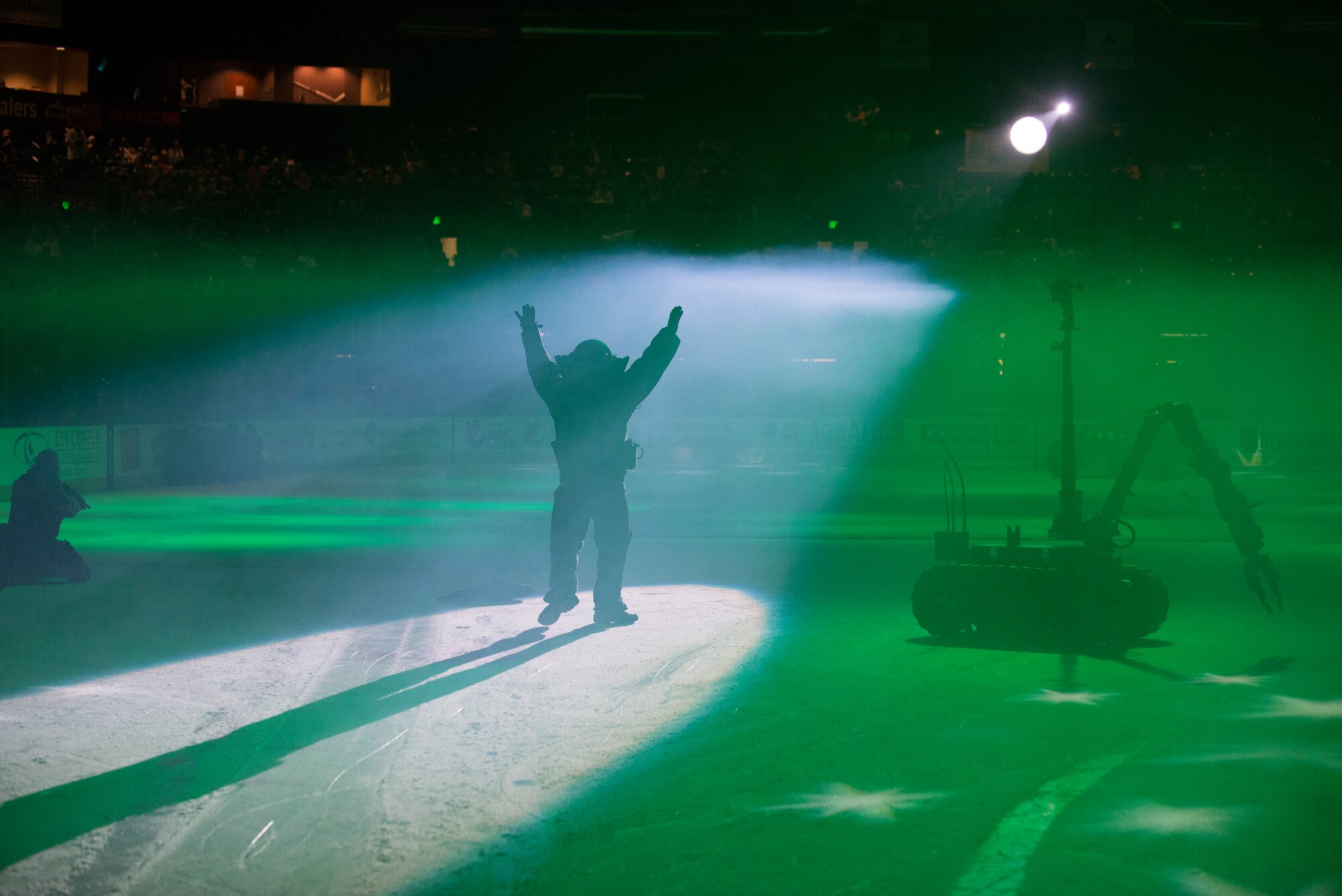 Staff Sgt. Cory Ahlf, 90th Civil Engineering Squadron Explosive Ordnance Disposal flight, entertains the crowd, Nov. 5, 2014, during a military demonstration at a Colorado Eagles hockey game in Loveland, Colo. As part of a military appreciation night, former Navy SEALs delivered the ceremonial game-puck and participated in a demonstration with 90th Civil Engineering Squadron EOD flight Airmen. (U.S. Air Force photo by Lan Kim)
