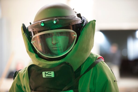 Staff Sgt. Cory Ahlf, 90th Civil Engineering Squadron Explosive Ordnance Disposal flight, poses in an EOD-9 bomb suit, Nov. 5, 2014, prior to going onto the ice rink of a Colorado Eagles hockey game in Loveland, Colo. Airmen from 90th Civil Engineering Squadron EOD flight and former Navy SEALs conducted  a military demonstration to entertain the crowd during the first intermission. (U.S. Air Force photo by Lan Kim)