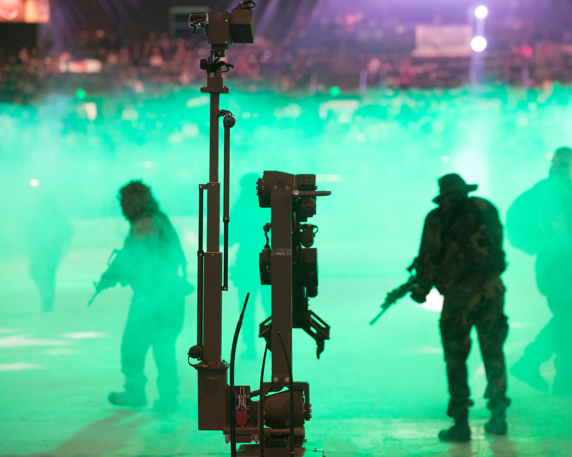 An Explosive Ordnance Disposal Wolverine Robot and former Navy SEALs make their way onto the ice rink of a Colorado Eagles hockey game, Nov. 5, 2014, to conduct a demonstration for the crowd in Loveland, Colo. EOD displayed the robot's capabilities and showed Eagles' fans a glimpse of military style tactics. (U.S. Air Force photo by Lan Kim)