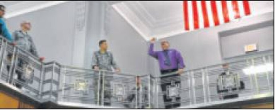 Tedmond Grady of AFLCMC sets his paper airplane in flight as other participants look on in the balcony of Bldg. 12’s rotunda. (Air Force photos by Diane Kofoed)