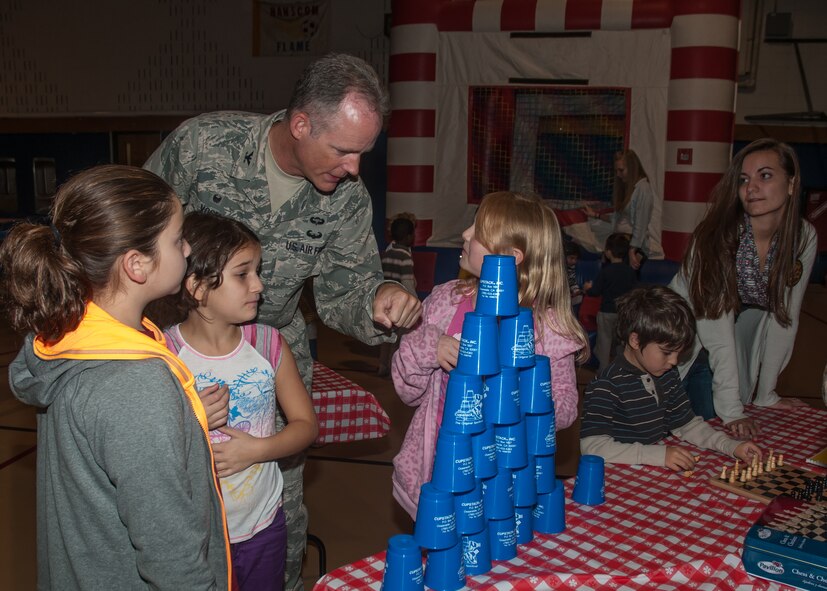 HANSCOM AIR FORCE BASE, Mass. - Col. Michael A. Vogel, 66th Air Base group
commander, speaks with children during a Month of the Military Family celebration at the Youth Center Nov. 5. Efforts to recognize the sacrifices of the military family by active duty, Guard and Reserve leaders are being joined and supported by Defense Department organizations to include the Army Air Force Exchange Service, Defense Commissary Agency and others. (U.S. Air Force Photo by Jennifer Green-Lanchoney)
