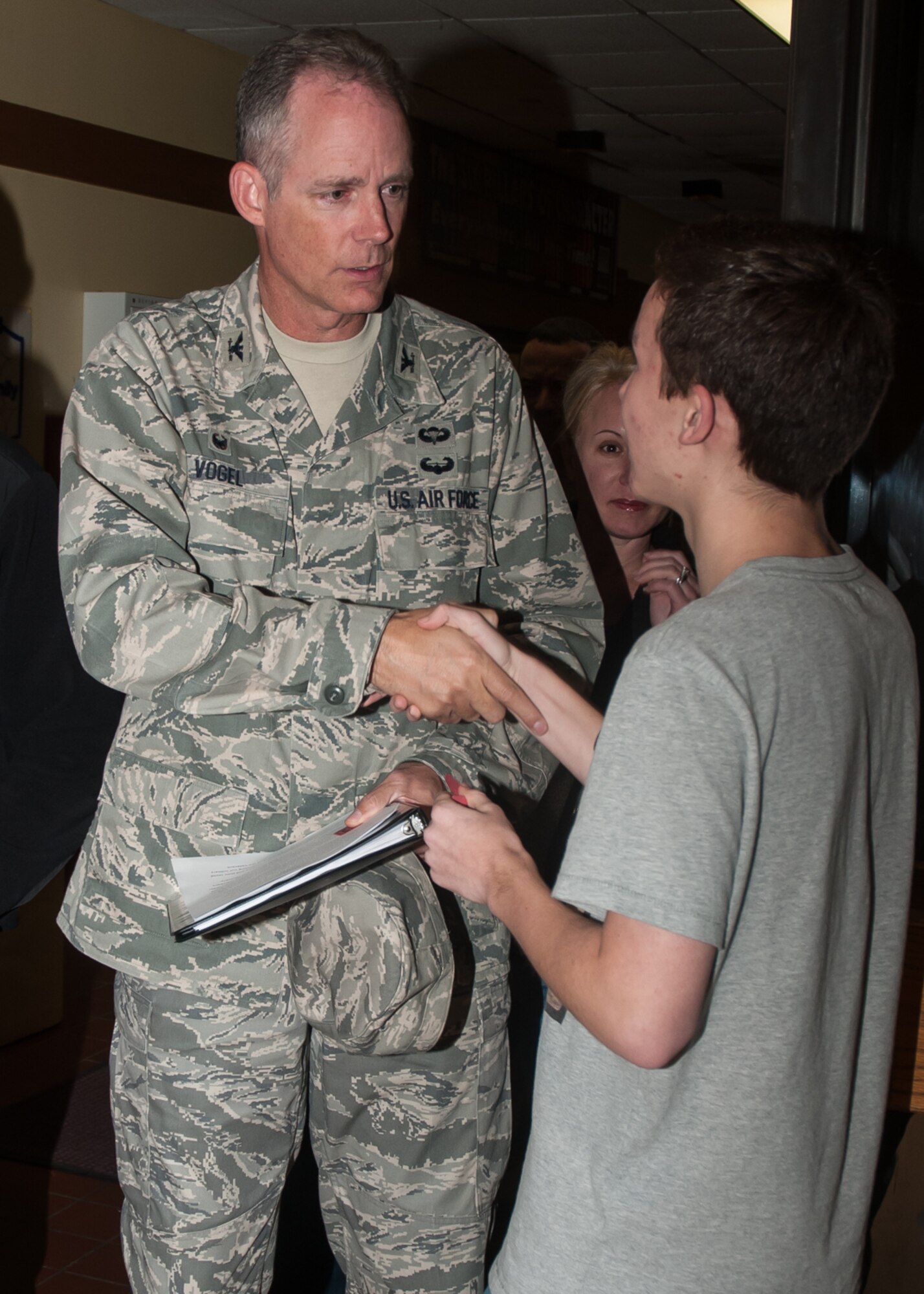 HANSCOM AIR FORCE BASE, Mass. -- Col. Michael A. Vogel, 66th Air Base Group
commander, shakes the hand of a base teen at the Youth Center during a Month
of the Military Family celebration Nov. 5. Throughout the month of November,
military families serving around the world are honored through a variety of
observances and recognized for their commitment and the many contributions
they make every day in support of the military and our nation. (U.S. Air
Force Photo by Jennifer Green-Lanchoney)
