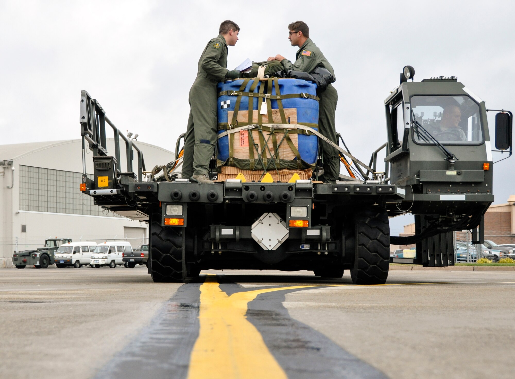 Two loadmasters with the 758th Airlift Squadron discuss the best way to approach the rear of a C-130 during a flight generation exercise on the flight line of Pittsburgh Internaitonal Airport Air Reserve Station, Nov. 1,2014.  The exercise is orchestrated to enhance the skills of the Airmen of the 911th. (U.S. Air Force photo by Senior Airman Joseph E. Bridge)
