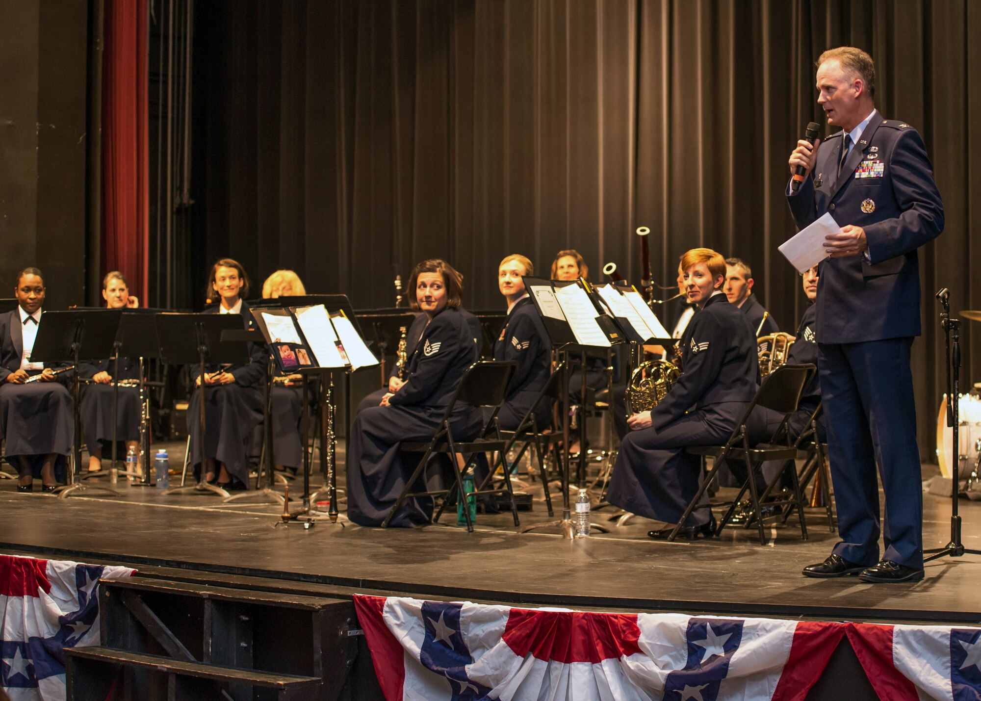 LEXINGTON, Mass. - Col. Michael A. Vogel, 66th Air Base Group commander, welcomes the Langley Winds during a performance at Lexington High School
Nov. 6. Langley Winds is an acoustic group of approximately 15 performers
and is part of the United States Air Force Heritage of America Band out of
Joint Base Langley-Eustis, Va.  (U.S. Air Force Photo by Walter Santos)

