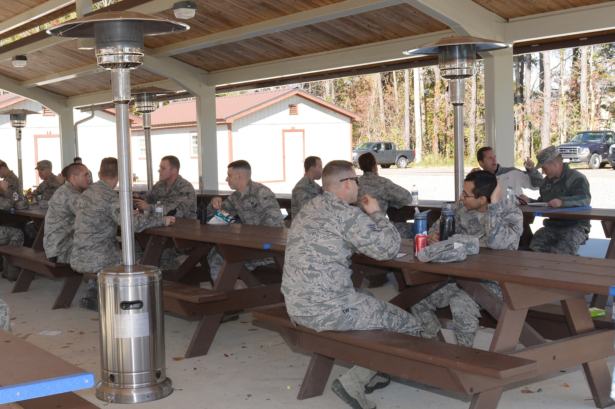 U.S. Air Force Airmen eat during an appreciation barbeque at the Langley Transit Center at Langley Air Force Base, Va., Nov. 7, 2014. The LTC is comprised of 21 buildings, including dormitories, bathroom and shower facilities, fitness center, cafeteria, and an entertainment and recreation center -- all built and managed by 633rd ABW personnel. (U.S. Air Force photo by Staff Sgt. Teresa J. Cleveland)