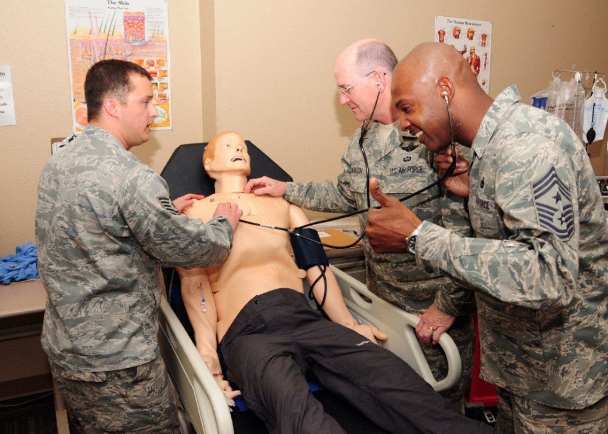 Lt. Gen. James “JJ” Jackson, Air Force Reserve Command commander and Chief Master Sgt. Cameron B. Kirksey, Air Force Reserve Command command chief, listen to the heartbeat of “Jason” the Laerdal 3G Simulation Maniken while Tech. Sgt. Tymmothy Roy, 944th Aeromedical Staging Squadron Air Reserve Technician health services manager, demonstrates its capabilities Nov. 6 during a tour of the 944th Fighter Wing at Luke Air Force Base, Ariz. (U.S. Air Force photo taken by Tech. Sgt. Louis Vega Jr.)