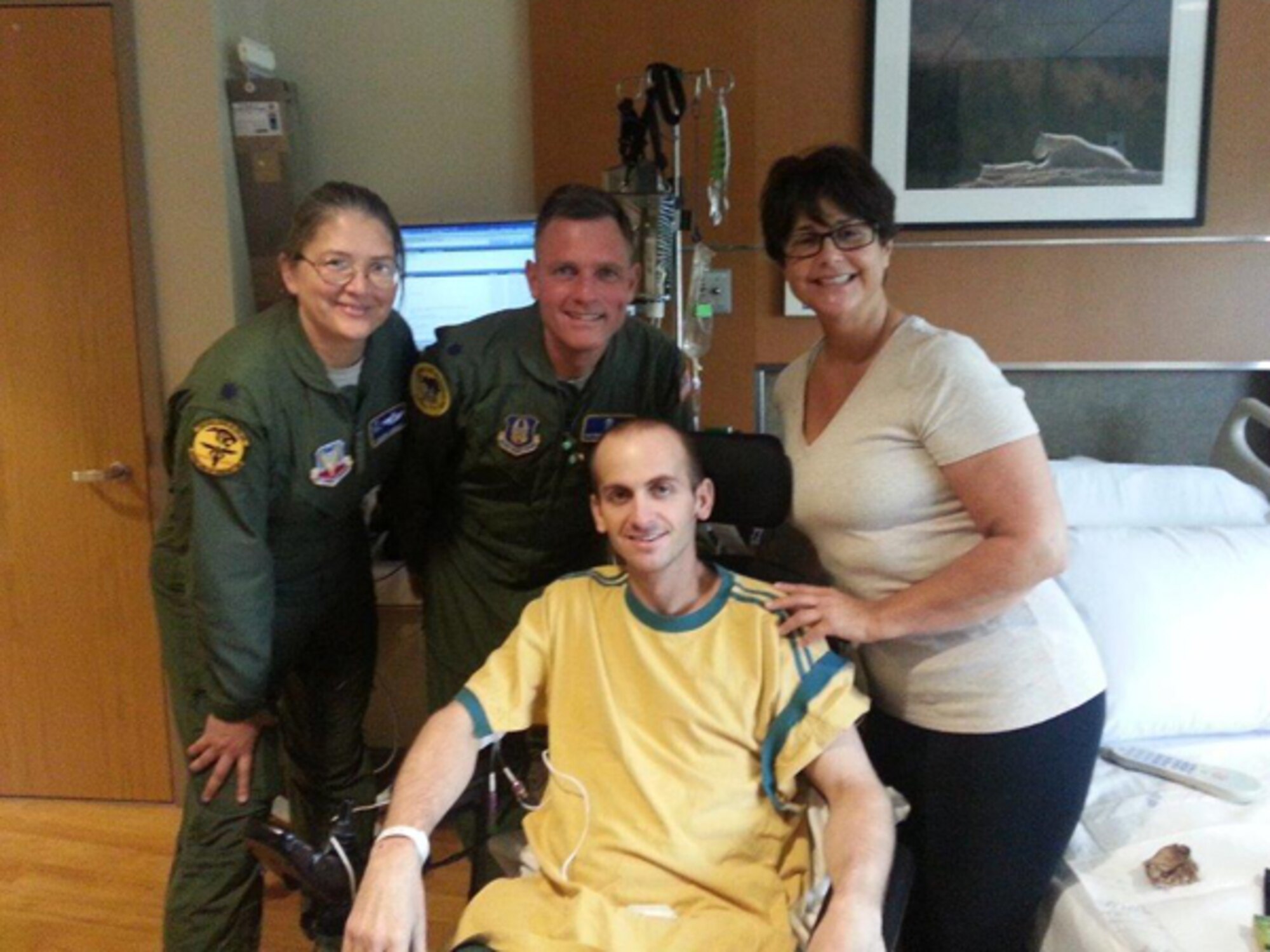 Members of the 10th Expeditionary Aeromedical Evacuation Flight Critical Care Air Transport Team visit Levi Eaves and his mother Judy at Walter Reed National Military Medical Center. (Courtesy photo)