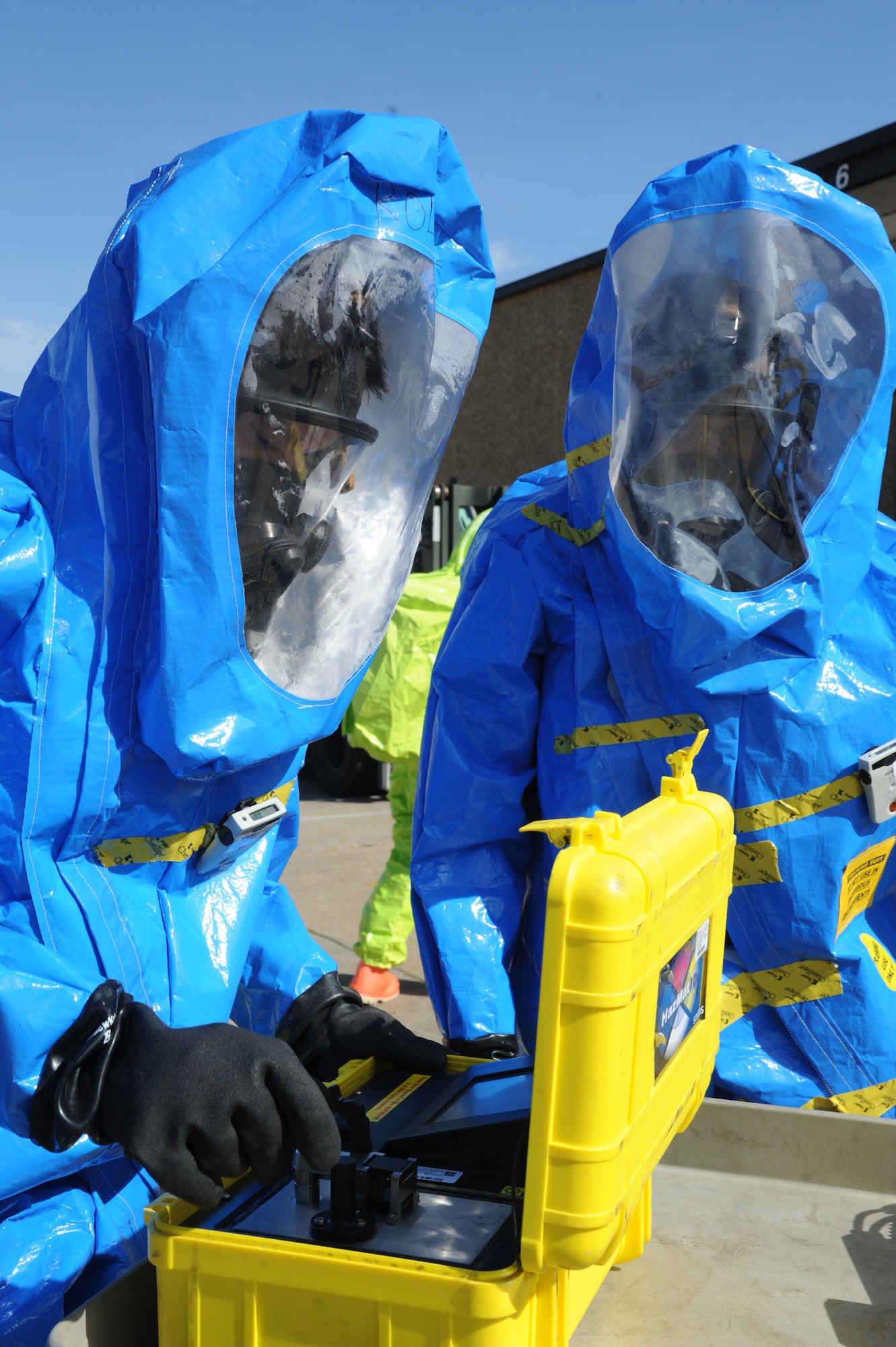 Senior Airman Greg Rollings and Airman 1st Class Devin Harris, 81st Aerospace Medicine Squadron bioenvironmental technicians, test a chemical agent spilled on-scene during a hazardous material exercise scenario Nov. 5, 2014, at the Taylor Logistics Center, Keesler Air Force Base, Miss.  The exercise scenario began with an Airman accidentally hitting a 55-gallon drum of sulfuric acid with a forklift and knocking several more drums off of a truck causing the liquid to splash onto other Airmen.  Immediately, the Airmen simulated skin and eye burns from exposure to the agent, while additional Airmen on the loading dock started coughing and experiencing shortness of breath. (U.S. Air Force photo by Kemberly Groue)