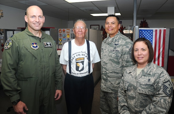 World War II veteran and member of Easy Company of the United States Army's 506th Parachute Infantry Regiment, 101st Airborne Division, Bradford Freeman, poses for a photo with Lt. Col. Bob Mozeleski, 14th Operations Groups Deputy Commander, Chief Master Sgt. Timothy Garcia, 14th OG Superintendent, and Master Sgt. Maria Rodriguez, 14th OG First Sergeant, during Freeman’s brief tour of the 14th OG building. During his visit, Freeman met with Airmen, shared stories and got to see a T-1 simulator in action. (U.S. Air Force photo/1st Lt. Joshua Benedetti)
