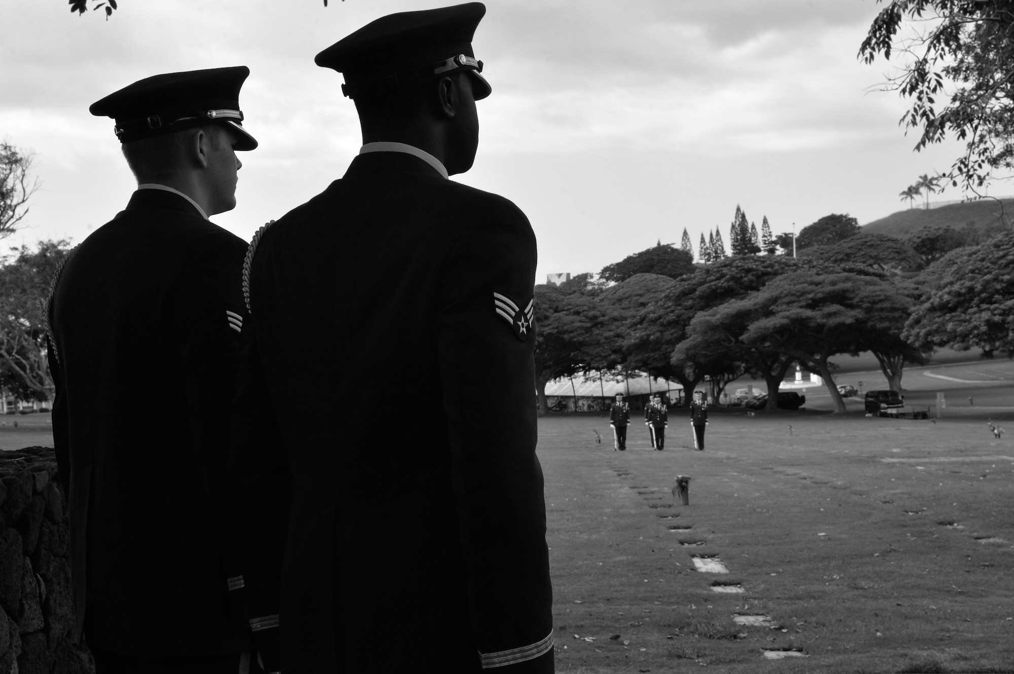 Hickam Honor Guard members observe the conclusion of a three-volley salute before a funeral ceremony at the National Memorial Cemetery of the Pacific in Honolulu, Hawaii, Nov. 4, 2014. The Honor Guard members practiced going through a funeral ceremony in order to ensure they execute the actual ceremony with no mistakes. The Hickam Honor Guard is the busiest in the Pacific, and one of the busiest in the Air Force providing the majority of their ceremony support for the Hawaiian Islands. (U.S. Air Force photo by Staff Sgt. Alexander Martinez)