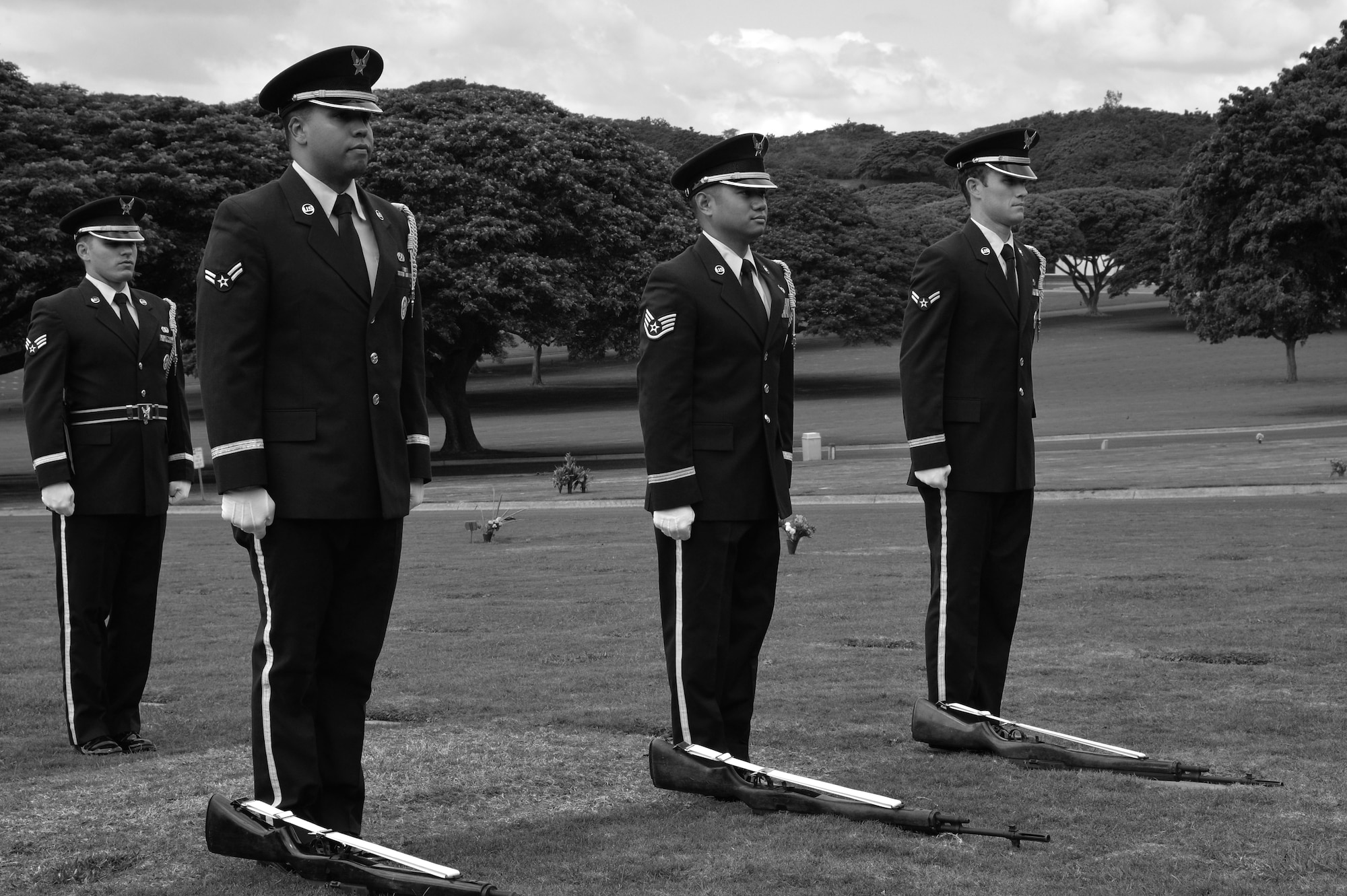 Hickam Honor Guard members prepare to pick up their rifles and render a three-volley salute before a funeral ceremony at the National Memorial Cemetery of the Pacific in Honolulu, Hawaii, Nov. 4, 2014. The Honor Guard members practiced going through a funeral ceremony in order to ensure they execute the actual ceremony with no mistakes. The Hickam Honor Guard is the busiest in the Pacific, and one of the busiest in the Air Force providing the majority of their ceremony support for the Hawaiian Islands. (U.S. Air Force photo by Staff Sgt. Alexander Martinez)