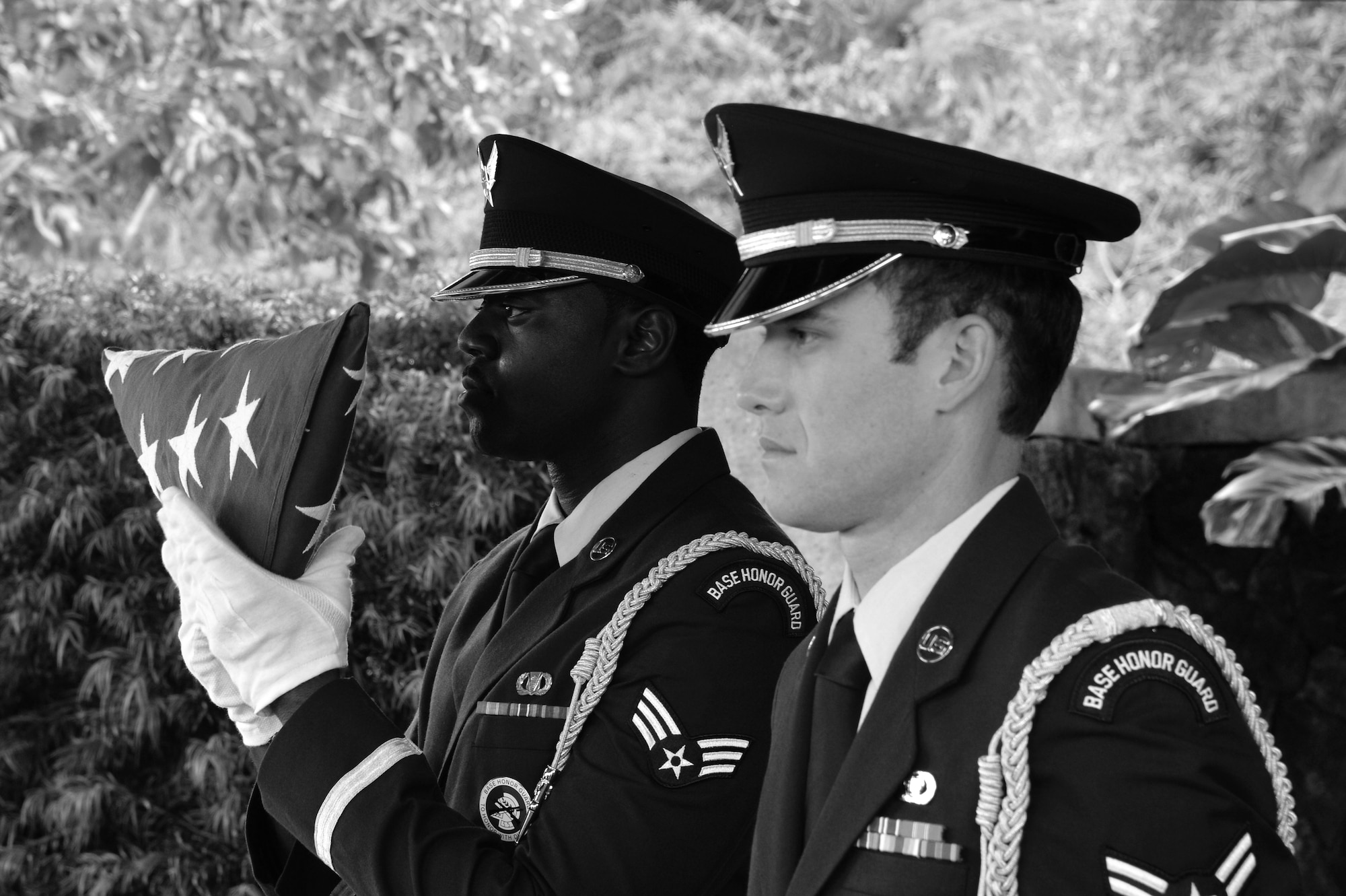 Senior Airman Ladarrion Holloway (left), Hickam Honor Guard member, practices the movements of presenting a U.S. flag to a fallen veteran’s next of kin before a funeral ceremony at the National Memorial Cemetery of the Pacific in Honolulu, Hawaii, Nov. 4, 2014. The Honor Guard members practice ceremony procedures on off days and before ceremonies in order to ensure they execute the mission with no mistakes. The Hickam Honor Guard is the busiest in the Pacific, and one of the busiest in the Air Force providing the majority of their ceremony support for the Hawaiian Islands. (U.S. Air Force photo by Staff Sgt. Alexander Martinez)