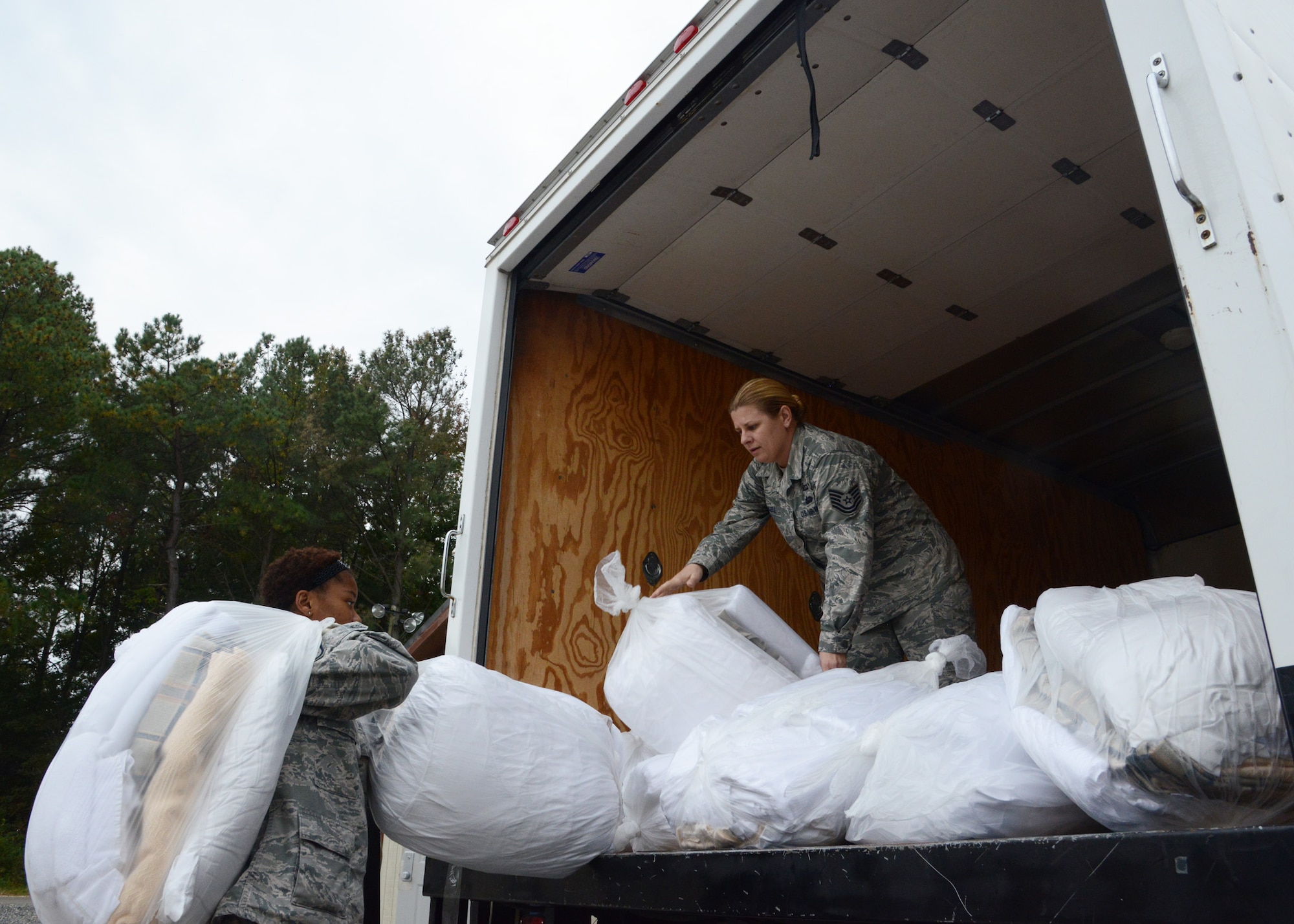 U.S. Air Force Airmen from the 633rd Air Base Wing unload fresh linens at the Langley Transit Center at Langley Air Force Base, Va., Nov. 5, 2014. The transit center was established in less than one week to comfortably accommodate U.S. Service members returning from Ebola response missions in West Africa that are undergoing the Department of Defense-mandated 21-day  controlled monitoring period. (U.S. Air Force photo by Staff Sgt. Jason J. Brown/Released)