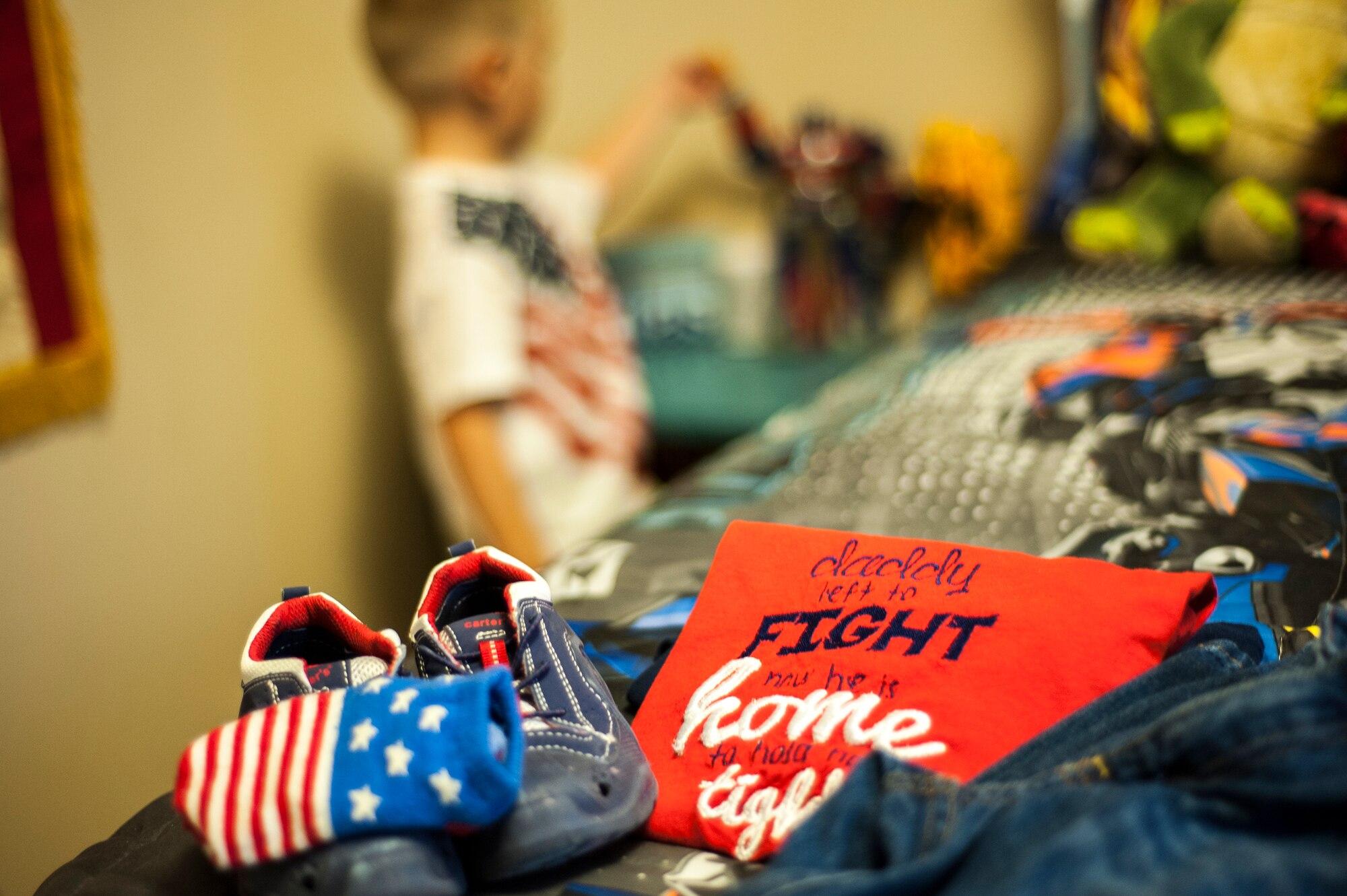 A patriotic outfit lays on the bed of Silas Lanthorn, son of U.S. Air Force Staff Sgt. Lee Lanthorn, at their home in Valdosta, Ga., Nov. 5, 2014. The t-shirt was embroidered to commemorate dad’s deployment homecoming. (U.S. Air Force photo by Andrea Jenkins/Released)