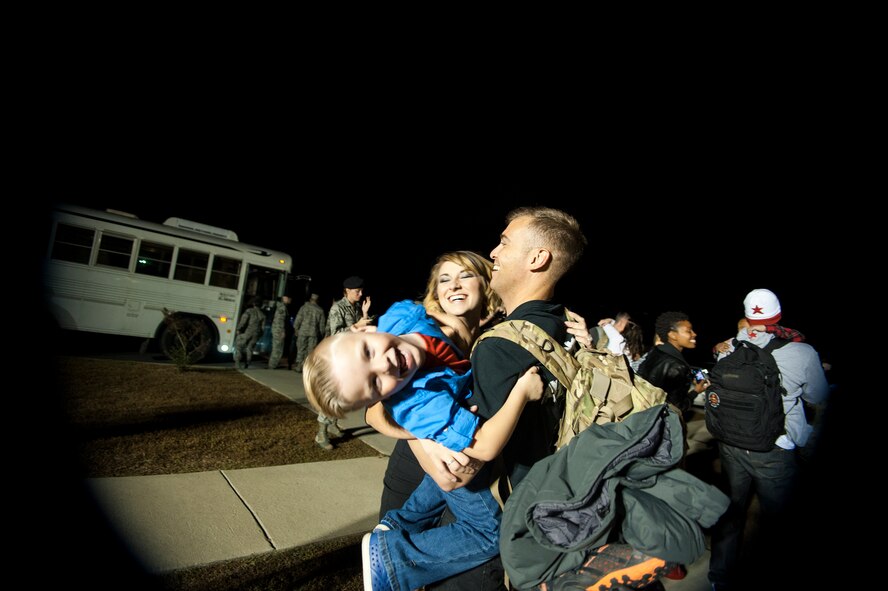 U.S. Air Force Staff Sgt. Lee Lanthorn, 822nd Base Defense Squadron, reunites with his wife Shelley and son Silas at Moody Air Force Base, Ga., Nov. 5, 2014, after returning from a six month deployment. During his third deployment, Lanthorn provided security detail for personnel in Afghanistan.(U.S. Air Force photo by Andrea Jenkins/Released)