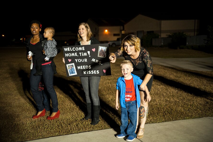 Shelley Lanthorn points to her husband, U.S. Air Force Staff Sgt. Lee Lanthorn, as he exits a bus at Moody Air Force Base, Ga. Nov. 5, 2014.  Family members and 822nd Base Defense Squadron leadership waited for Airmen returning from deployment to be bused from the airport. (U.S. Air Force photo by Andrea Jenkins/Released)