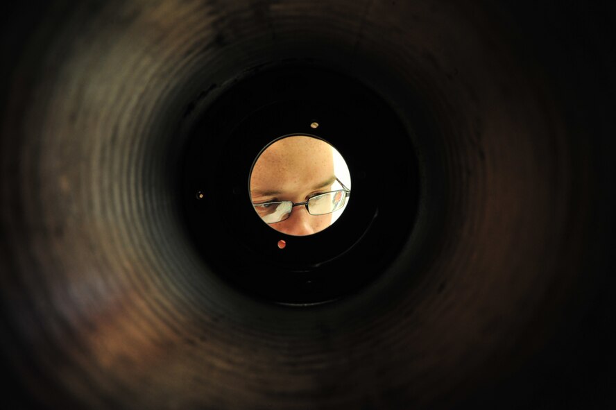 U.S. Air Force Airman 1st Class Mason Roberts, 355th Equipment Maintenance Squadron weapons armament technician, inspects the scoop disc of a 30 mm ammunition drum at Davis-Monthan Air Force Base, Ariz., Nov. 6, 2014. The scoop disc aids in transferring the ammunition from the drum to the 30 mm GAU-8/A Gatling gun.  (U.S. Air Force Photo by Airman 1st Class Chris Massey/Released)