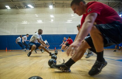 Joint Base Charleston Airmen participate in the monthly fitness challenge Nov. 7, 2014, at the Air Base fitness center on Joint Base Charleston, S.C. The monthly fitness challenge is a 628th Air Base Wing initiative intended to encourage teamwork and camaraderie as part of Comprehensive Airmen Fitness. (U.S. Air Force photo/Airman 1st Class Clayton Cupit)