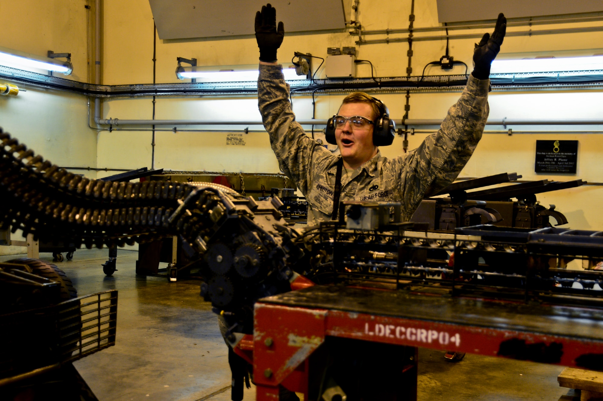 Staff Sgt. Seth Johnston, 48th Munitions Squadron conventional maintenance crew chief, celebrates the successful completion of processing the universal ammunition loading system for any missed 20 mm rounds at Royal Air Force Lakenheath, England, Nov. 3, 2014. The MUNS provides 24-hour coverage to support day-to-day flying. (U.S. Air Force photo by Airman 1st Class Erin R. Babis/Released)