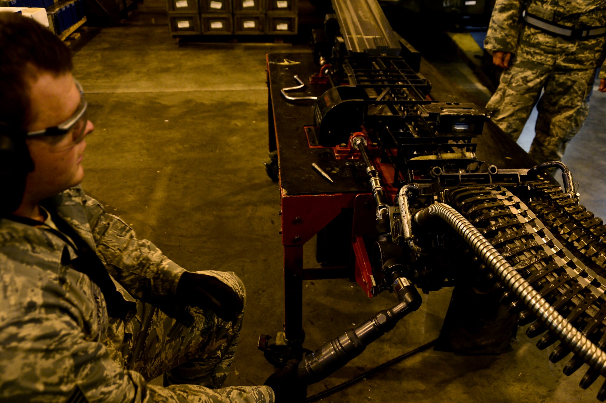 Staff Sgt. Seth Johnston, 48th Munitions Squadron conventional maintenance crew chief, utilizes a pneumatic gun with torque limiter attached to the replenishing table to process the universal ammunition loading system for any missed 20 mm rounds at Royal Air Force Lakenheath, England, Nov. 3, 2014. The 48th MUNS provides all explosives, to include bombs, 20 mm rounds, counter measures, marine markers and small arms, to the fighter squadrons and the rescue squadron. (U.S. Air Force photo by Airman 1st Class Erin R. Babis/Released)