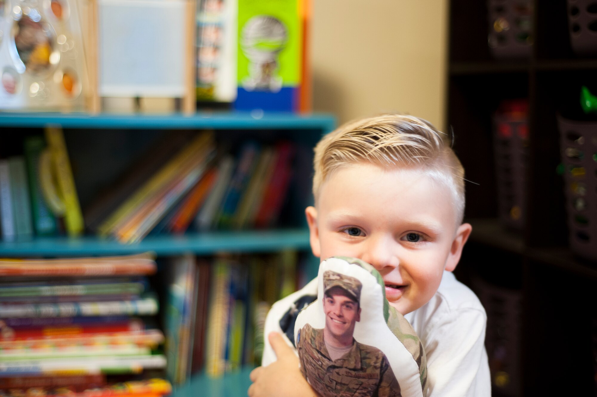 Silas Lanthorn, son of U.S. Air Force Staff Sgt. Lee Lanthorn, pauses before finishing a chalk drawing at their home in Valdosta, Ga., Nov. 5, 2014. Three-year-old Silas helped his mom Shelley decorate their driveway in preparation for his father’s return from a six month deployment.  (U.S. Air Force photo by Andrea Jenkins/Released)